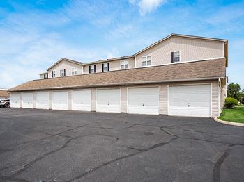 A large building with a garage door is in the foreground.
